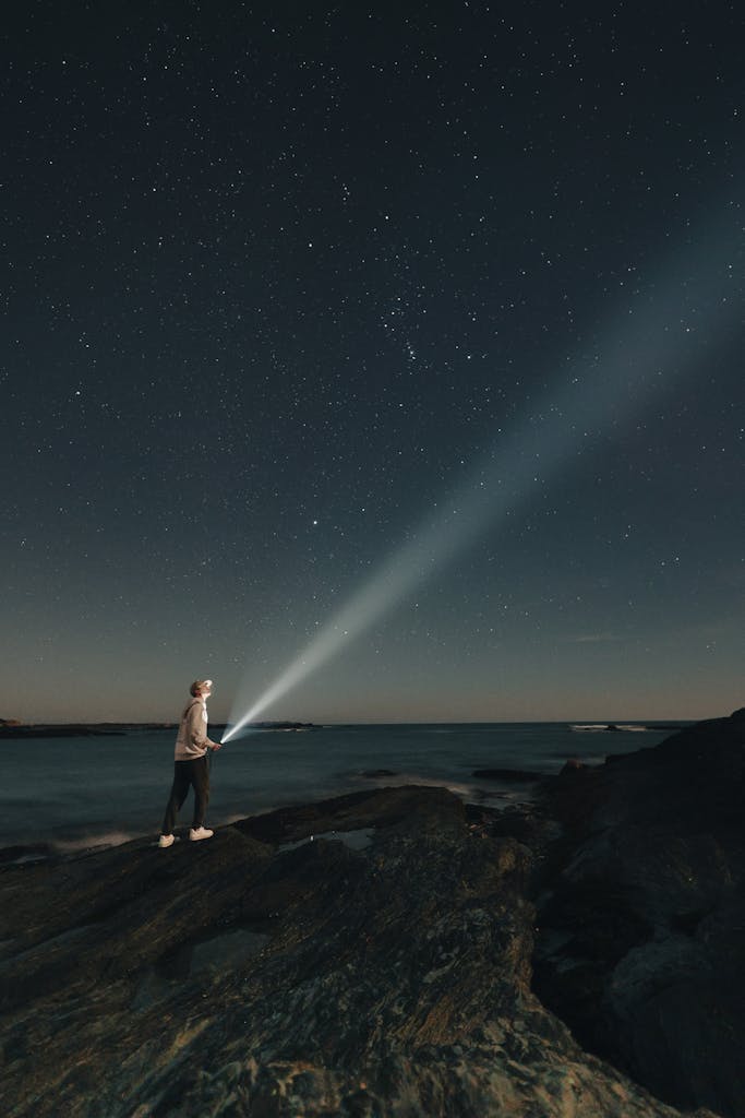 Person with Flashlight Looking at Stars